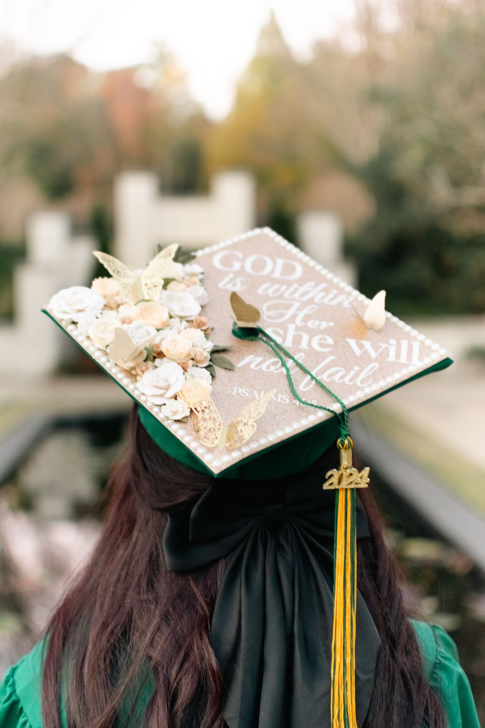 Decorated graduation cap with floral details and inspirational text.
