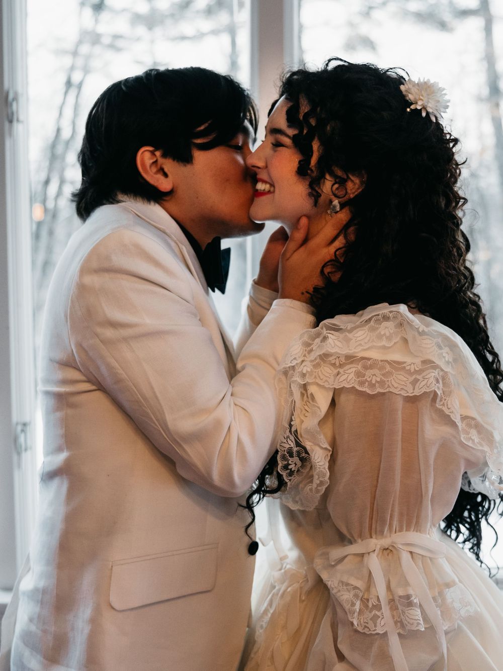 Sweet, happy winter wedding moment with bride and groom in Vermont.