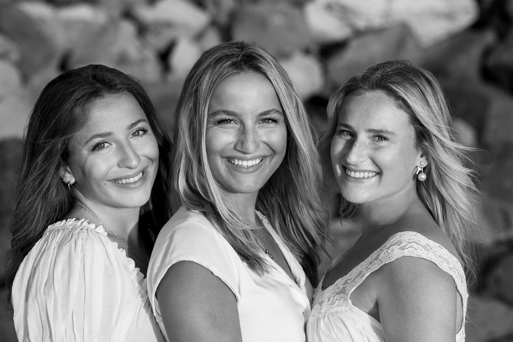 A black and white collage of women smiling and posing together in casual group photos.