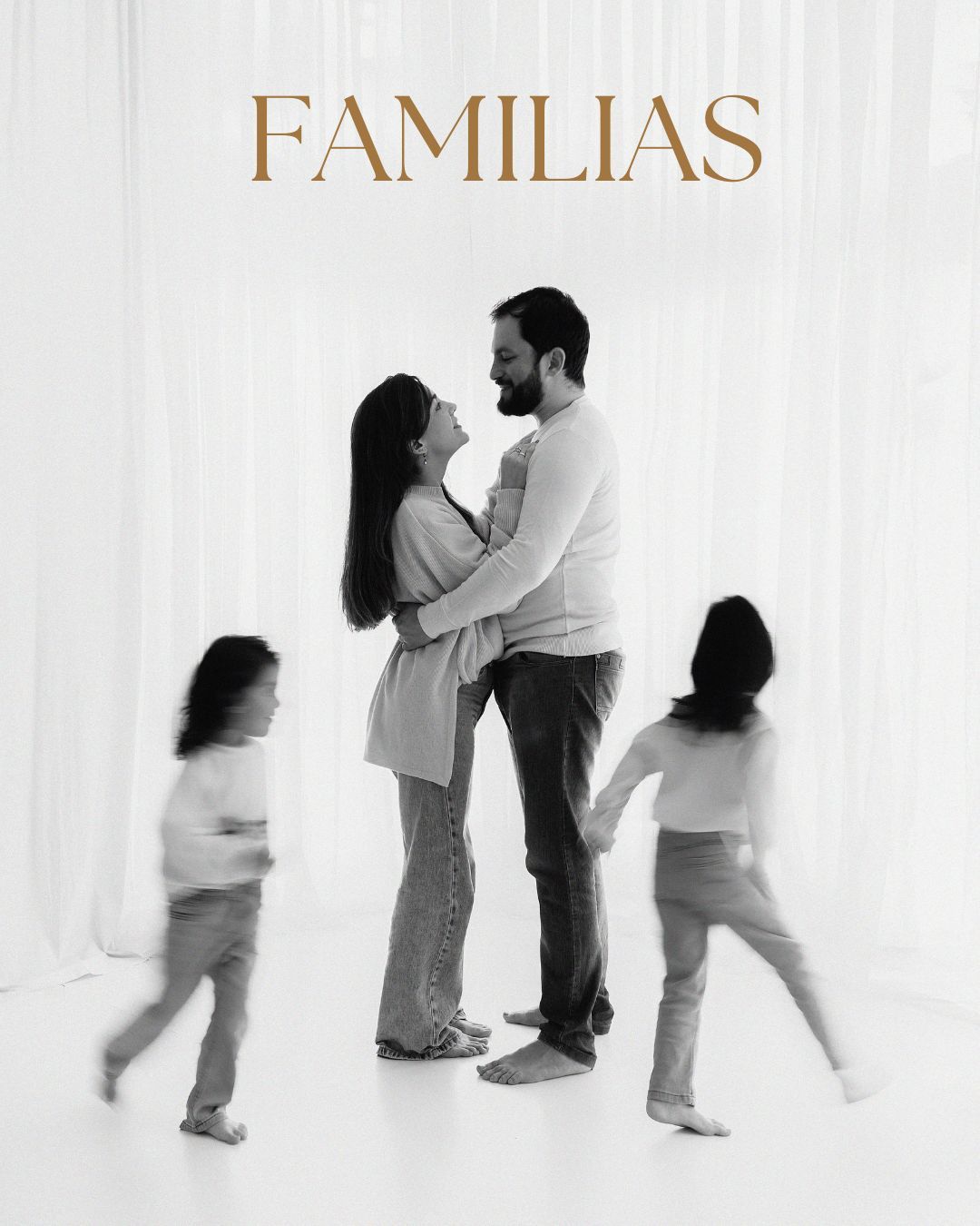 Family portrait with pampas grass decor against white backdrop.