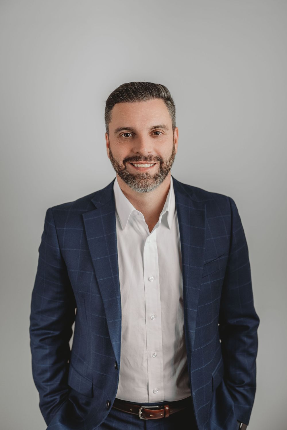 Business man posing for headshot on white backdrop in studio headshot session in Etobicoke