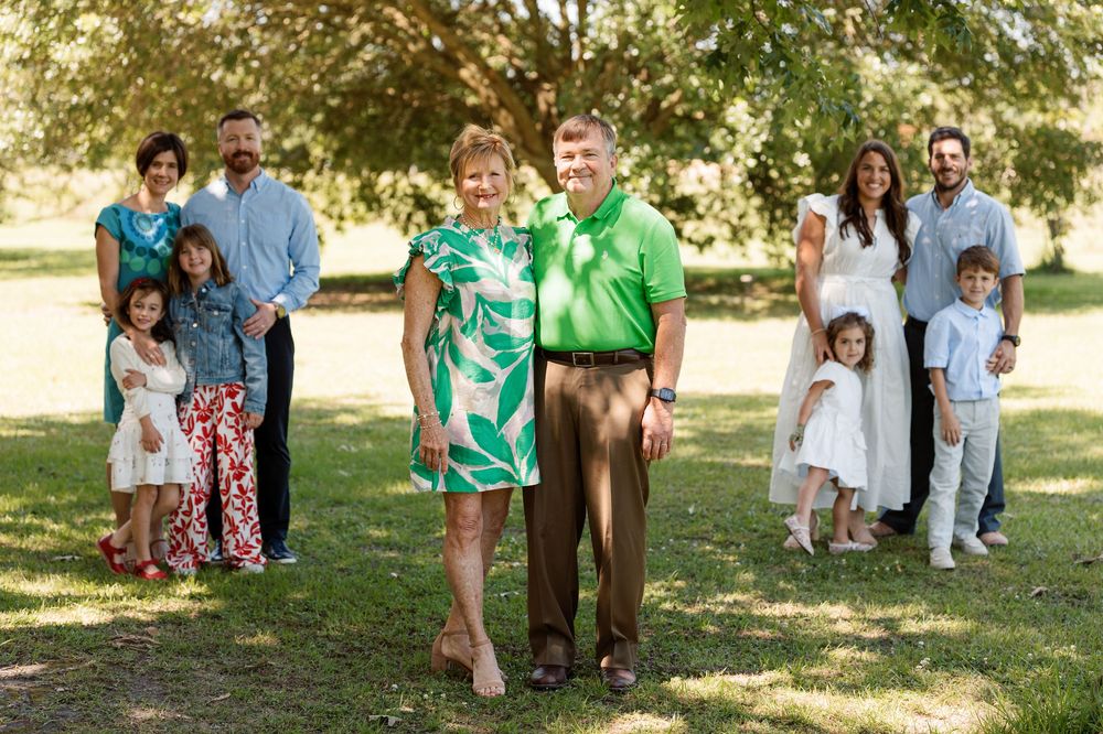 Family posing together among trees