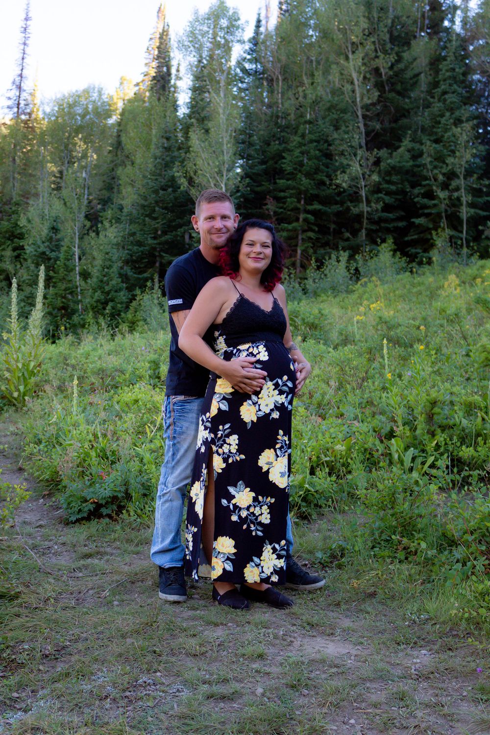 A series of photos taken in a forest clearing with two people interacting on the ground.