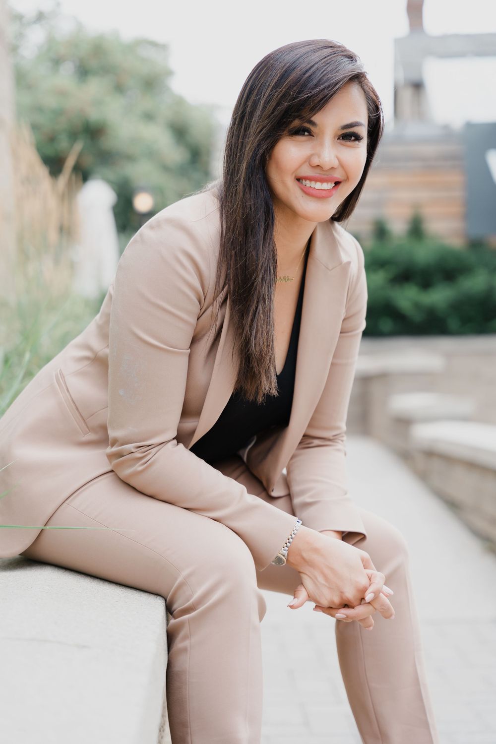 Natural light portrait with confident expression of a female boss seated in a office park location