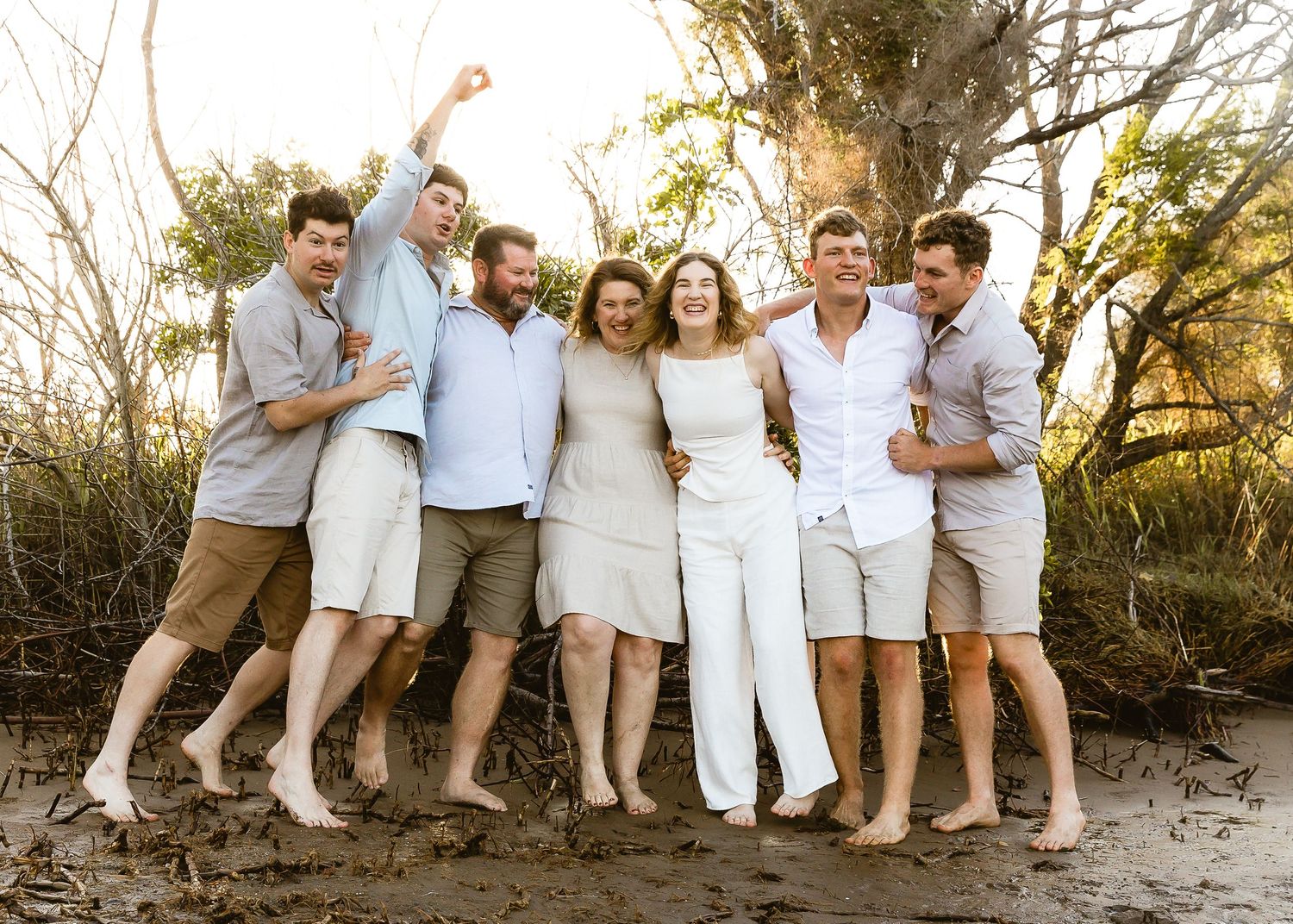 Grandfather wearing turban laughing with grandmother during family portrait shoot at Nudgee Beach in Brisbane
