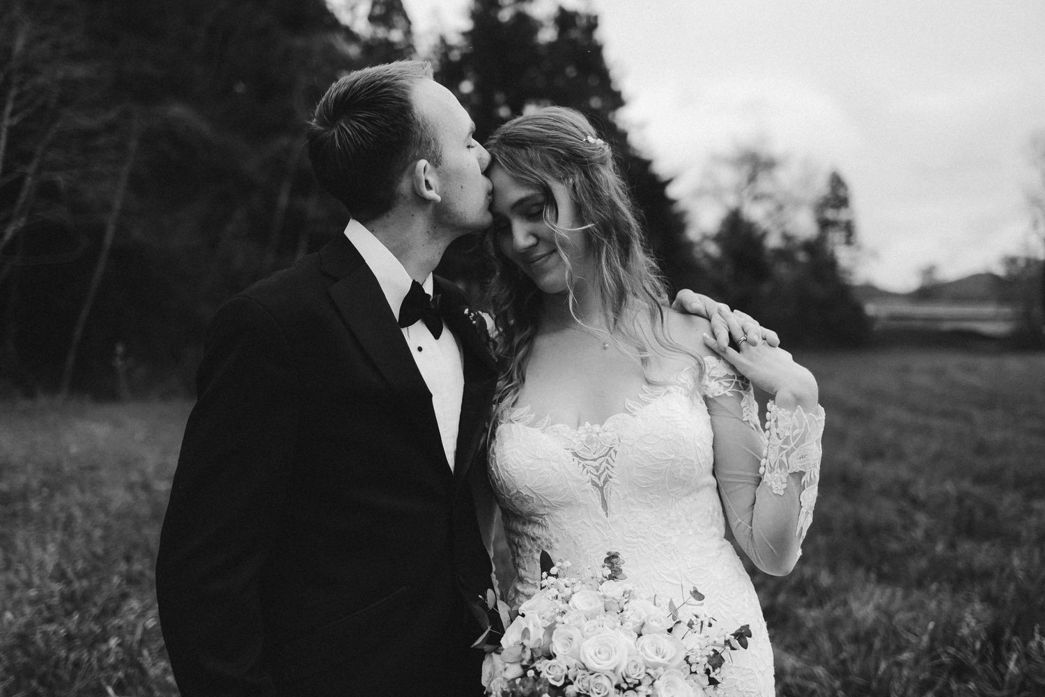 Bride and groom portrait with veil flying in the wind