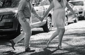 Black and white photo of couples dancing together outdoors in a vintage scene.