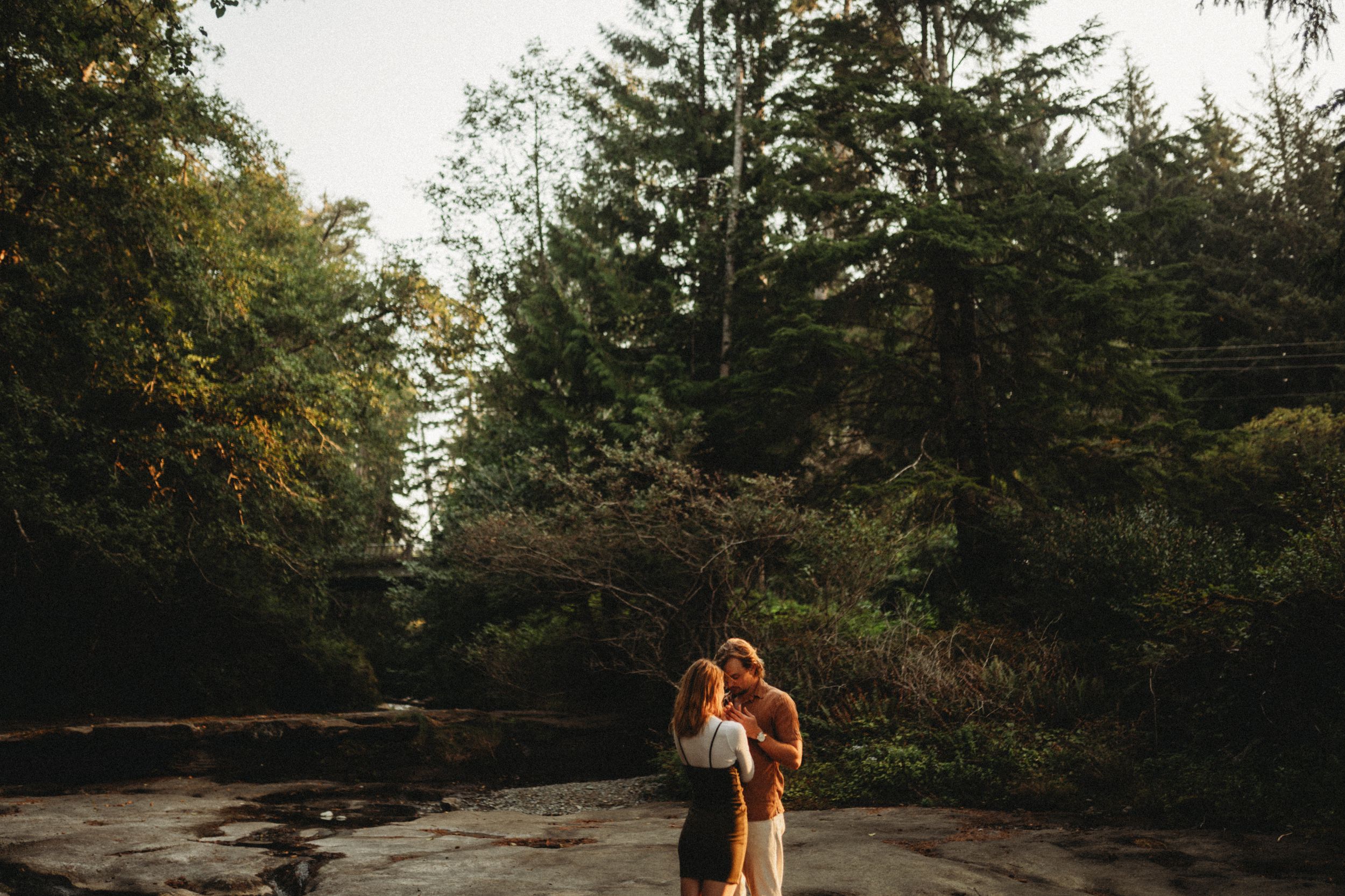 Couple photoshoot by the creek during golden hour on Vancouver Island.
