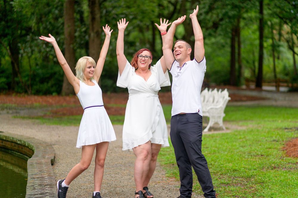 "Happy family enjoying a fun-filled photoshoot, capturing candid smiles and joyful moments in a beautiful outdoor setting."