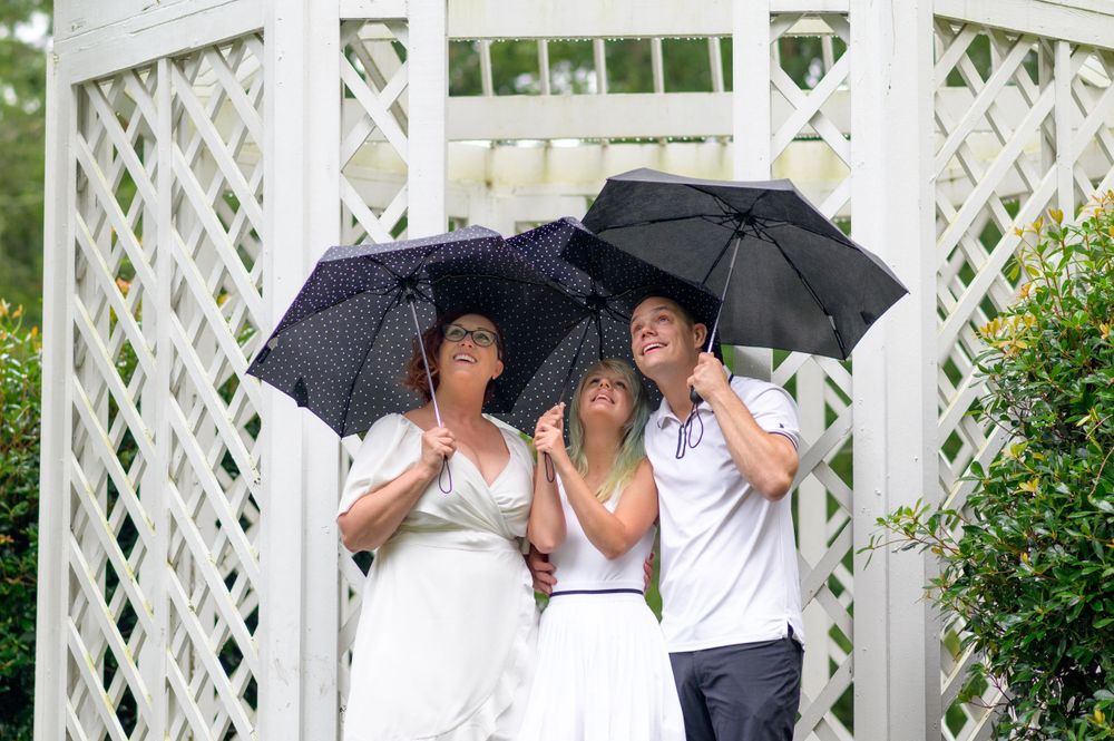 "Happy family enjoying a fun-filled photoshoot, capturing candid smiles and joyful moments in a beautiful outdoor setting."