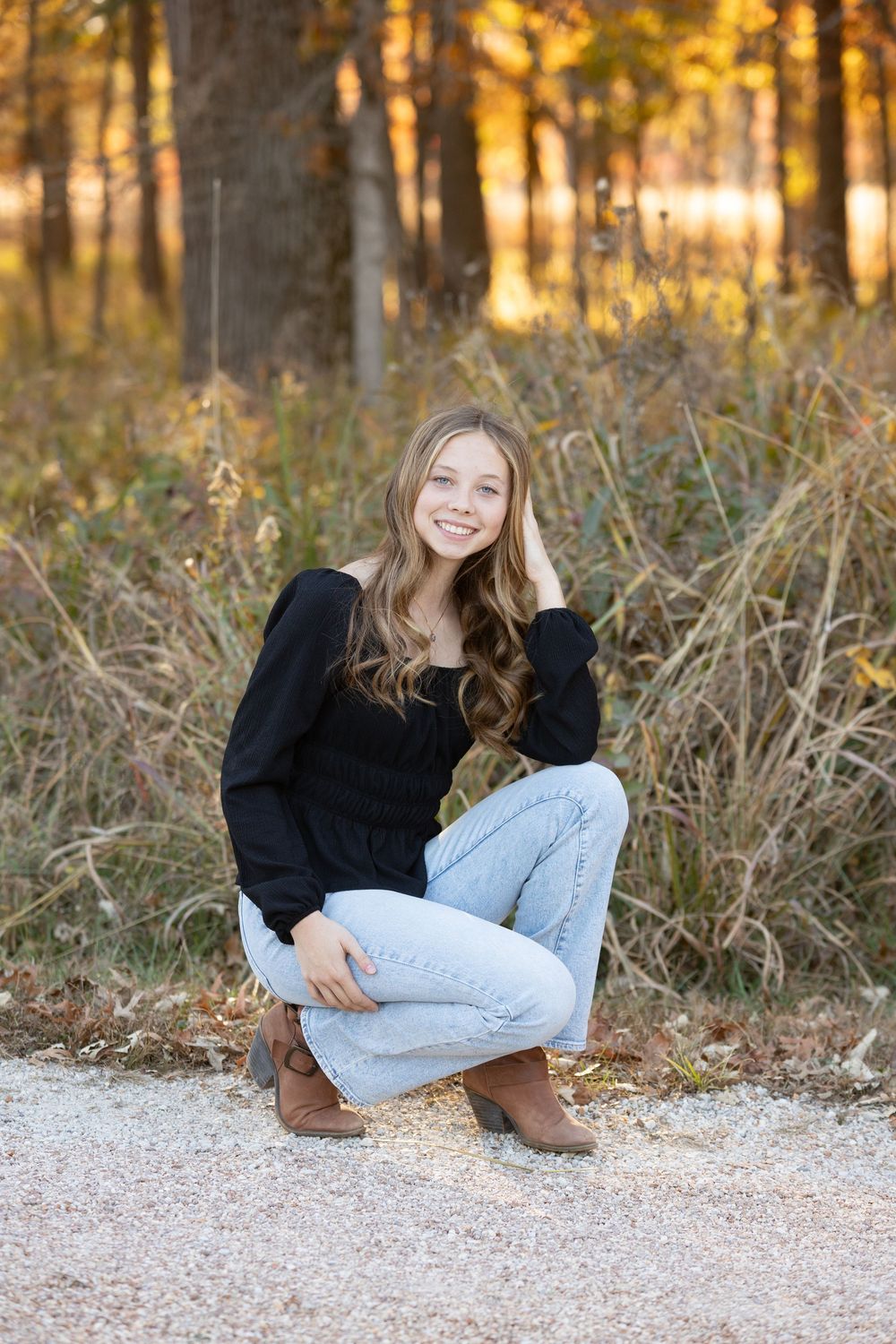 A series of outdoor portrait photos showing someone in a black sweater and jeans relaxing on a gravel path at sunset.