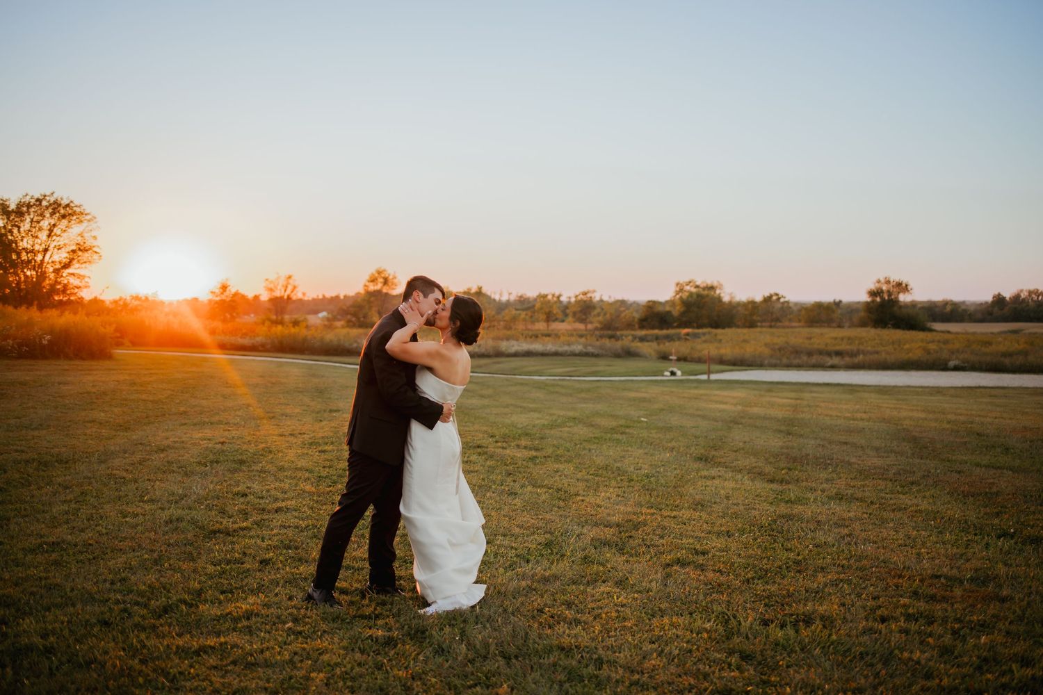 bride and groom share a kiss at Sunset in Zionsville Indiana
