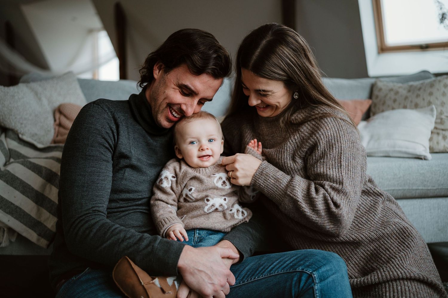 Candid family portrait showing intimate moments during an outdoor photo session.