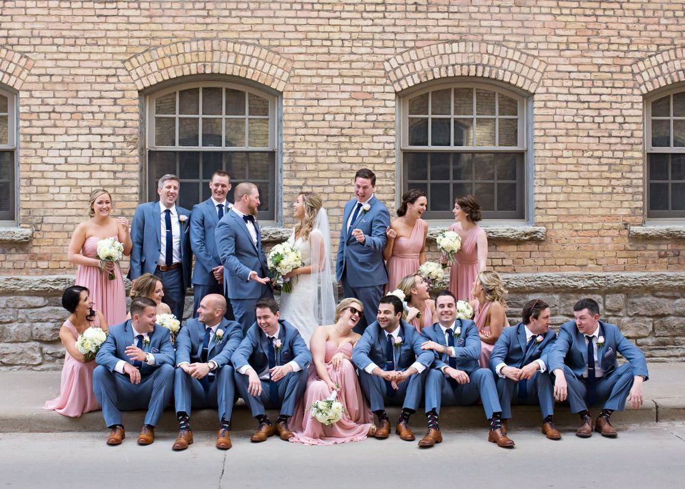 Bridal party photo at Appleton WI wedding, capturing fun, candid moments with bridesmaids and groomsmen in a relaxed outdoor setting.
