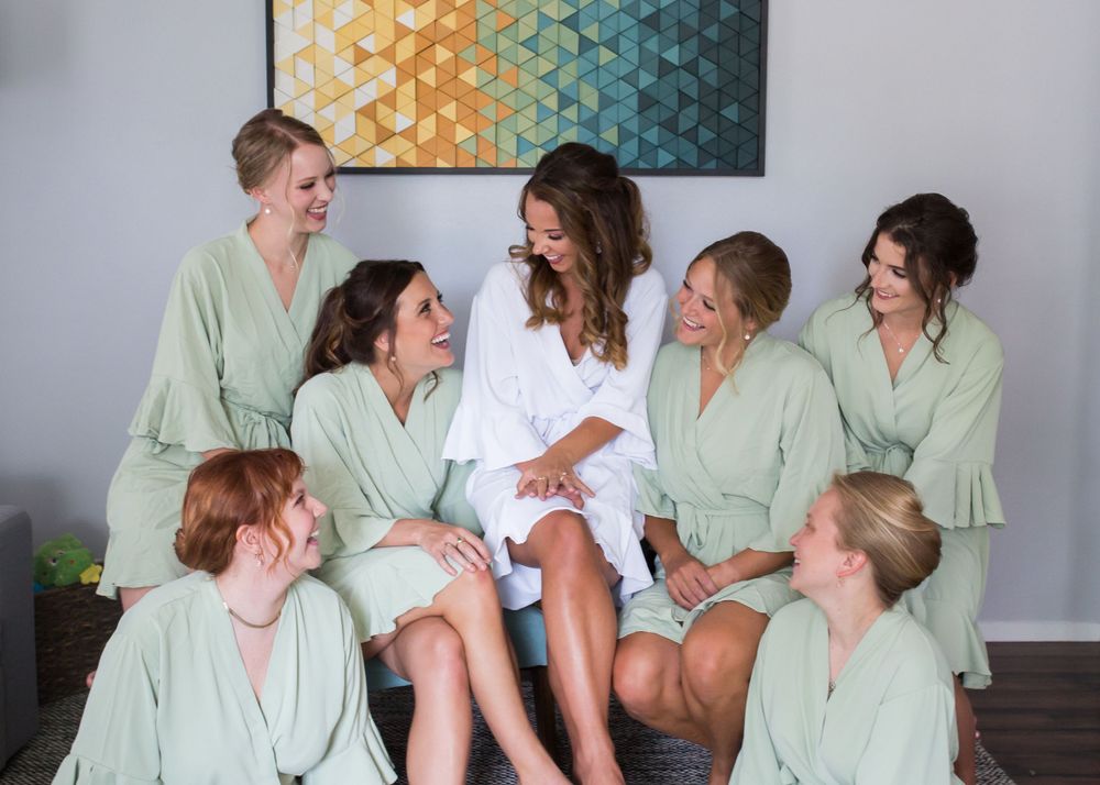 Bridal party photo at Appleton WI wedding, capturing fun, candid moments with bridesmaids and groomsmen in a relaxed outdoor setting.