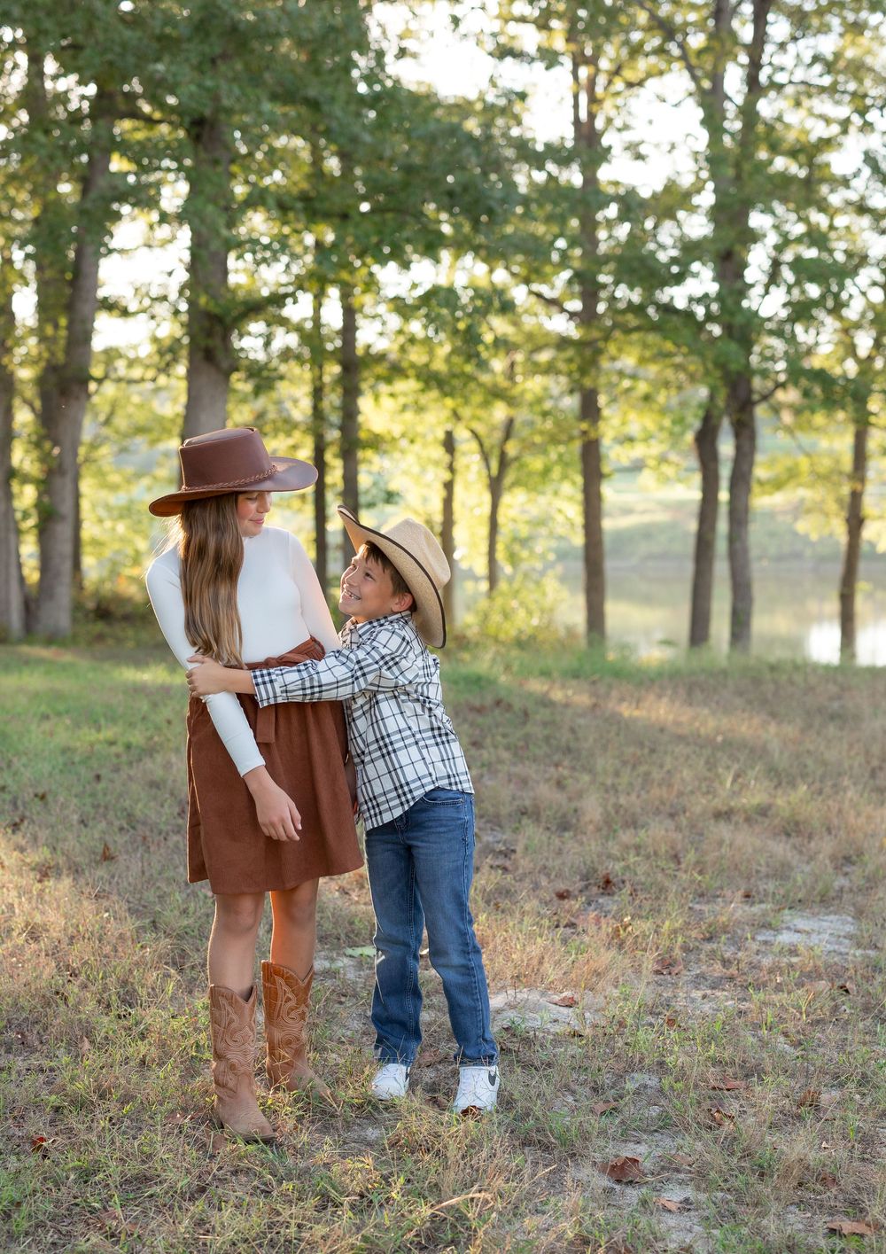 Four sequential photos showing a playful interaction between a parent and child in a wooded outdoor setting at sunset.