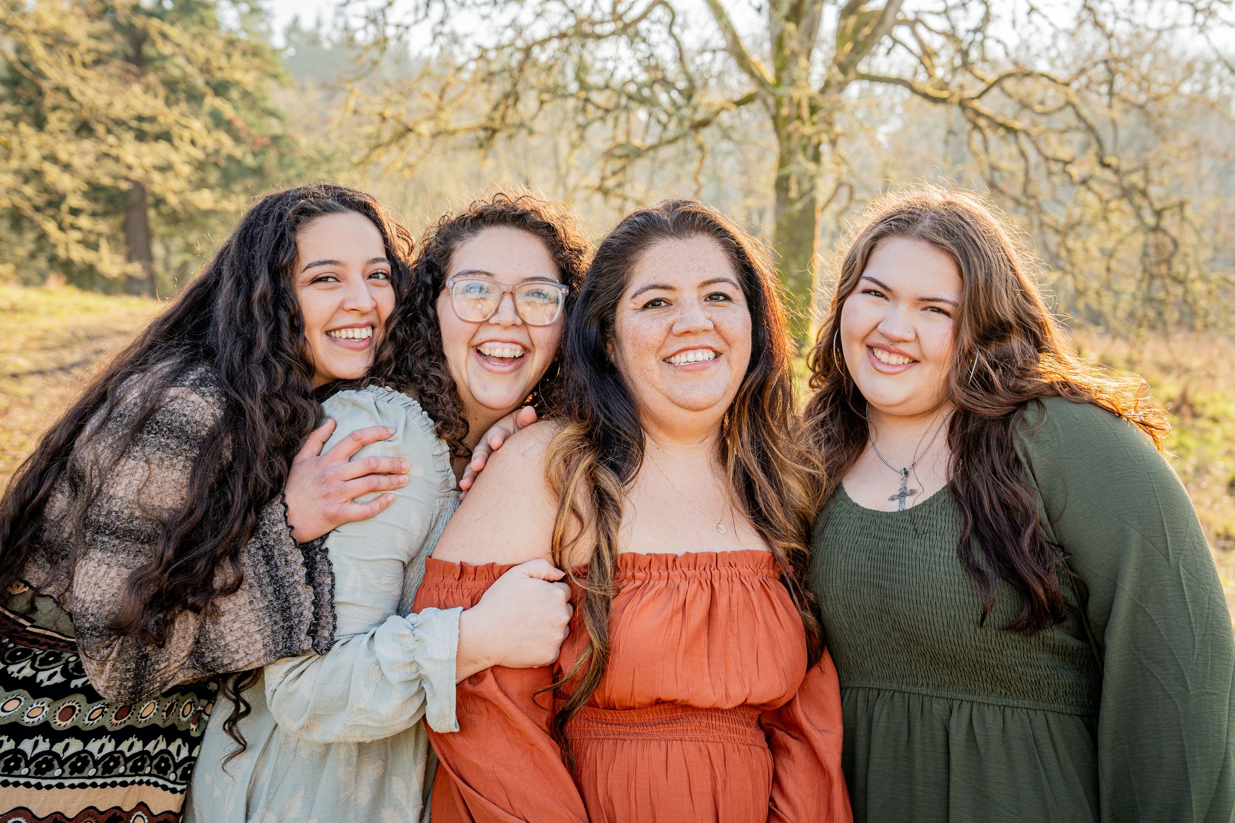 A group photo session outdoors featuring coordinated outfits in autumn colors of orange and olive green.