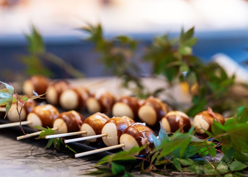 Grilled mushroom skewers garnished with fresh herbs on rustic wooden surface.