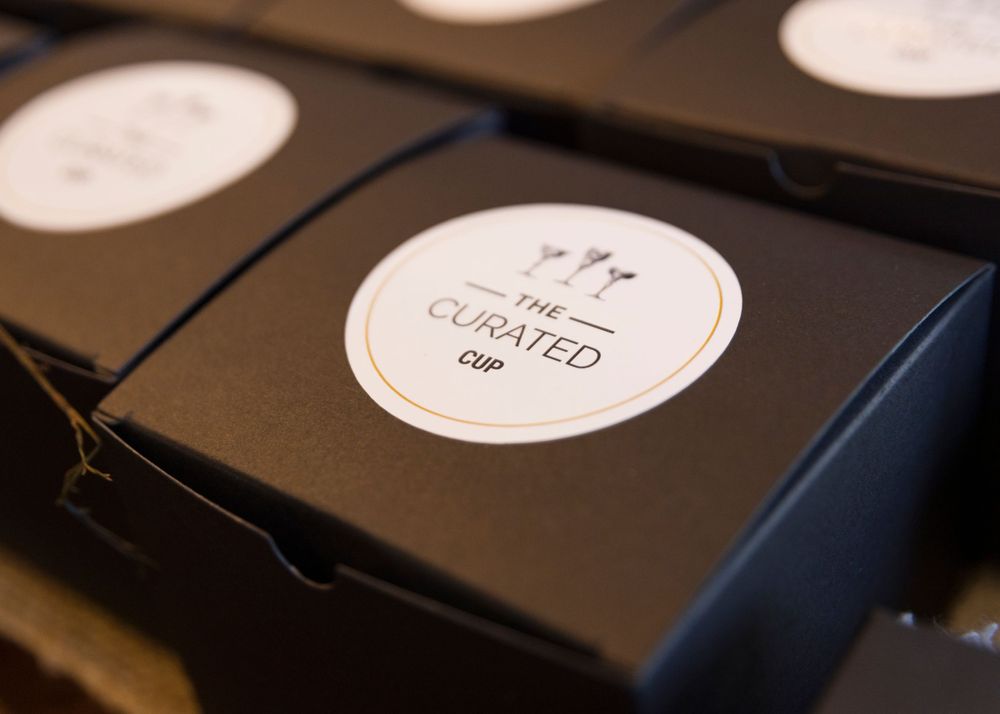 Black branded boxes with white circular labels arranged in rows.