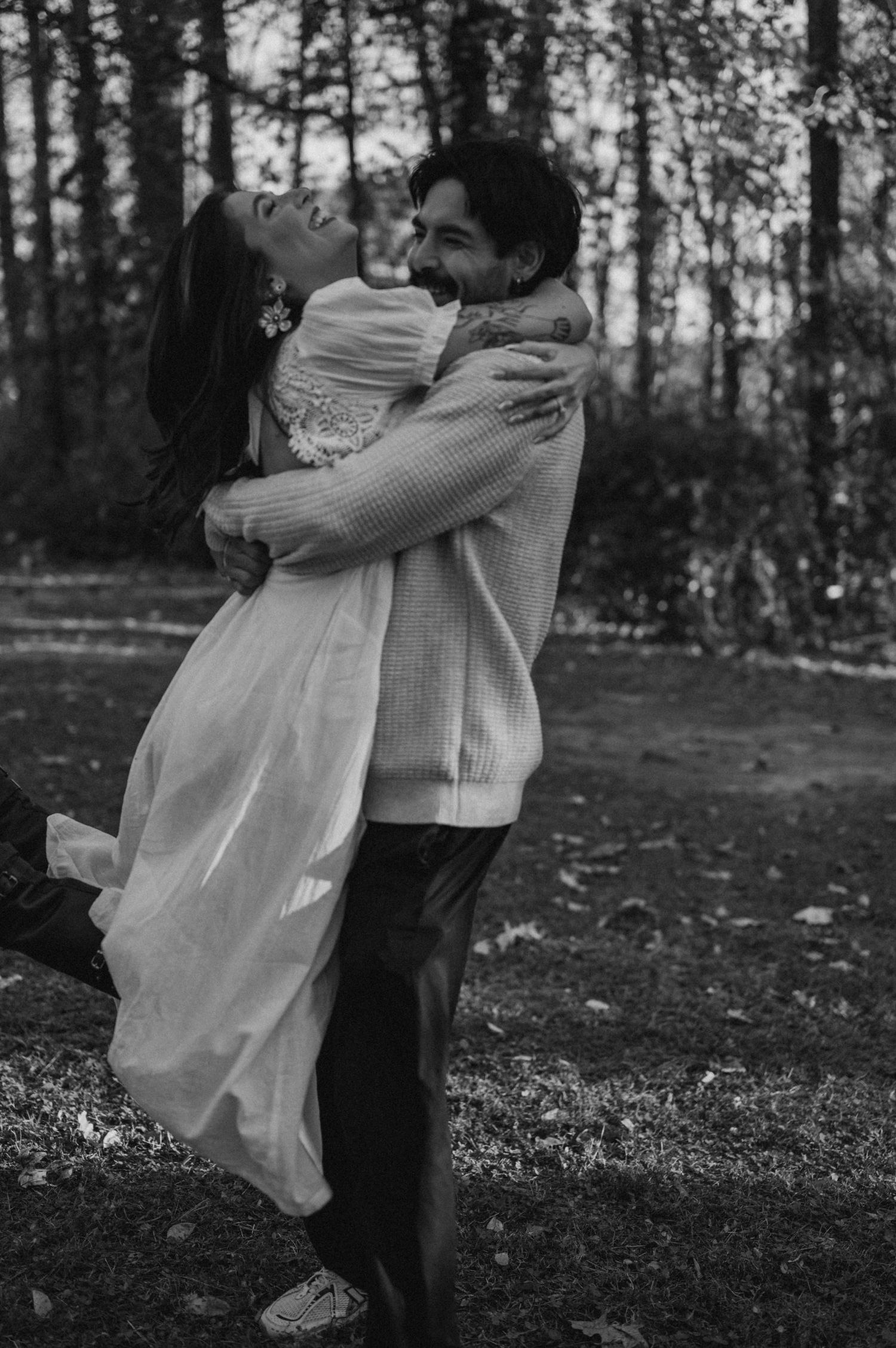 Black and white photos capture tender moments between a couple in a forest setting.