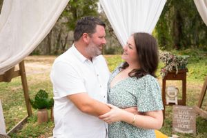 A romantic outdoor setting with white drapes and rustic decor.