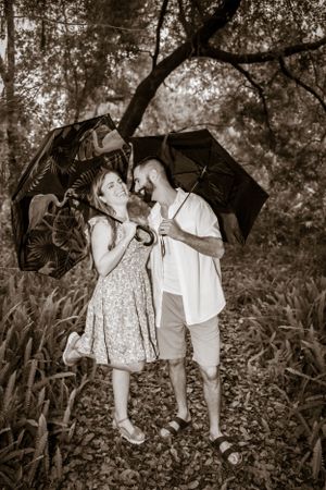 A black and white photo series capturing playful family moments outdoors.