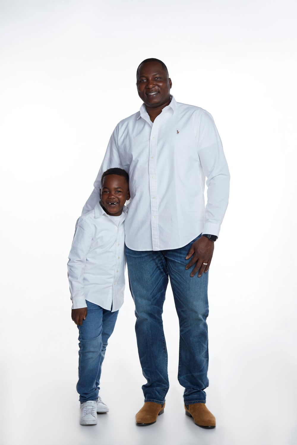 Classic studio photography featuring matching white shirts and blue jeans.