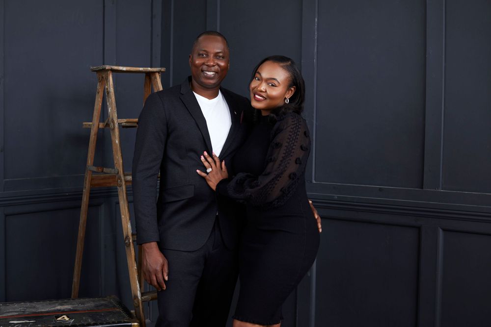 Studio photography session showing playful interactions against navy blue walls.