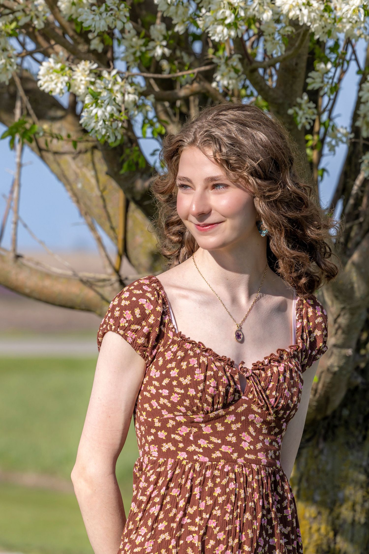 Senior posed against tree