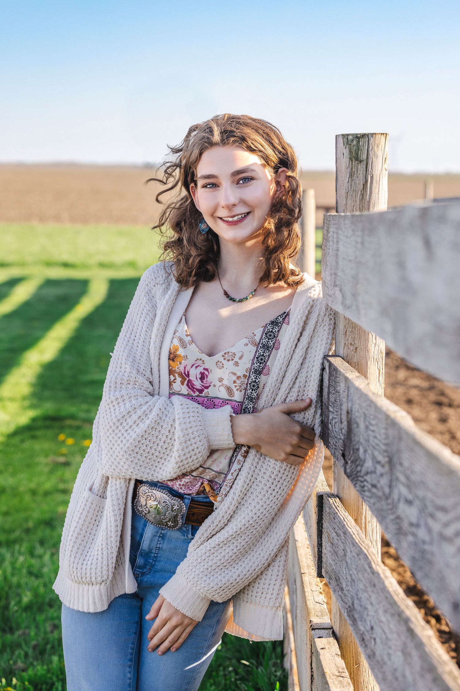 Senior posed against fence