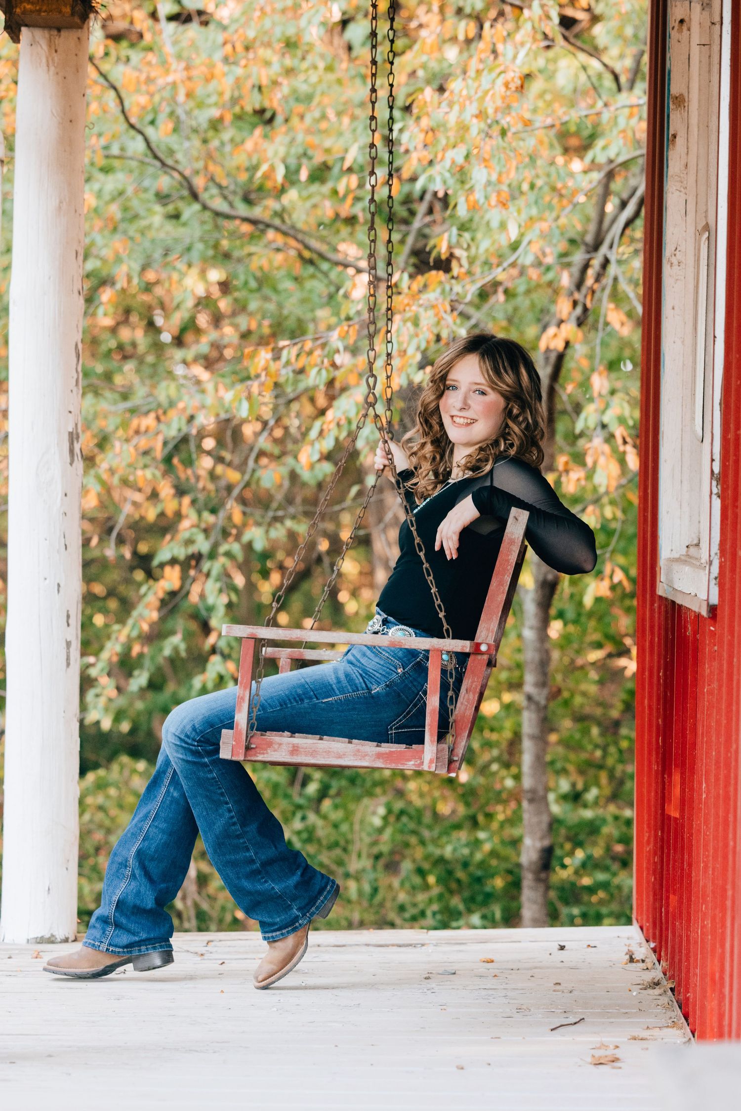 Senior posed on porch swing