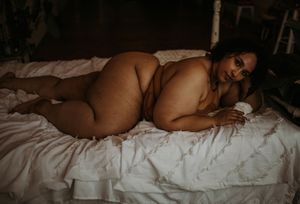 Figure reclines on white bedding in artistic boudoir pose captured from multiple angles.