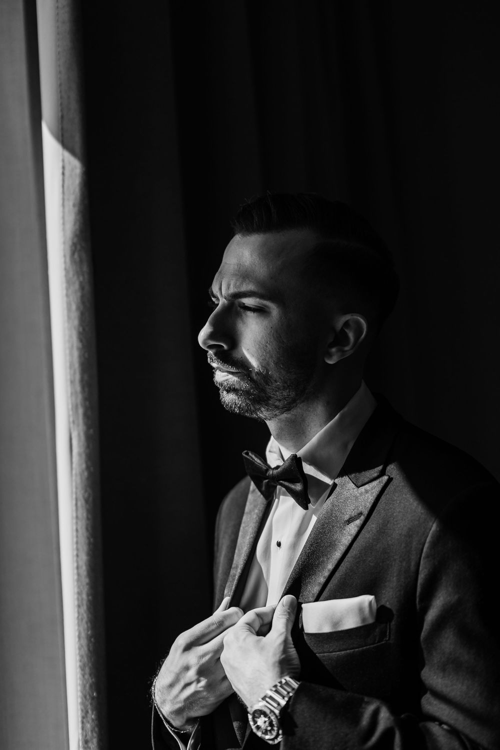 Dramatic side-lit black and white portraits showing details of a tuxedo and bowtie.