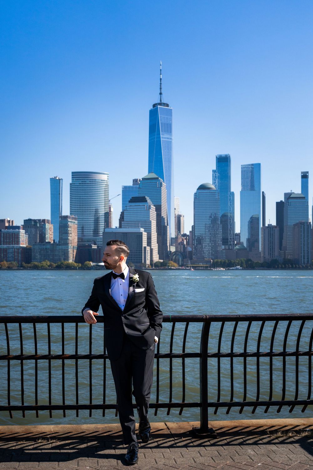 Wide shots of the Manhattan skyline and waterfront with person in formal wear.