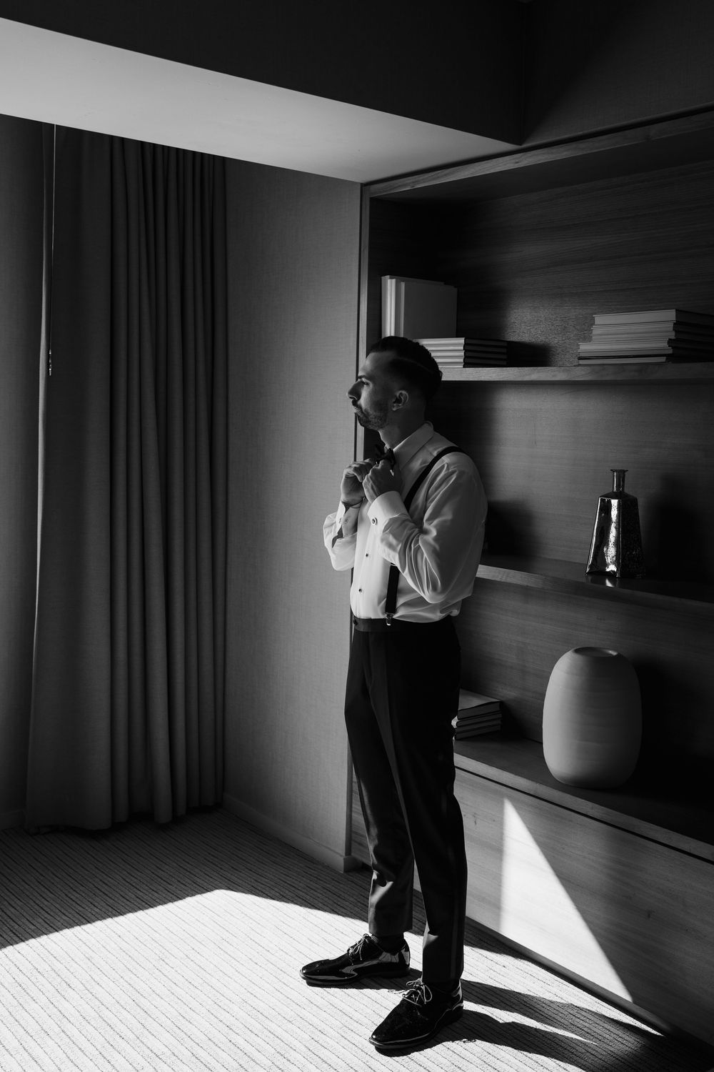 Dramatic black and white photos showing silhouettes against window light in a modern room.