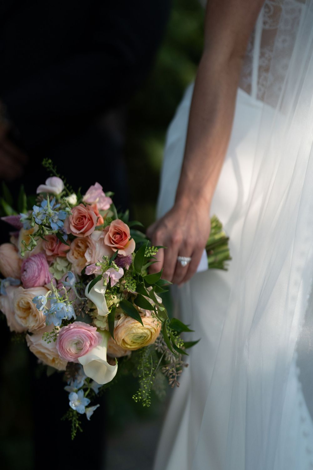 A series of elegant wedding bouquets with pink and peach roses against a white dress background.