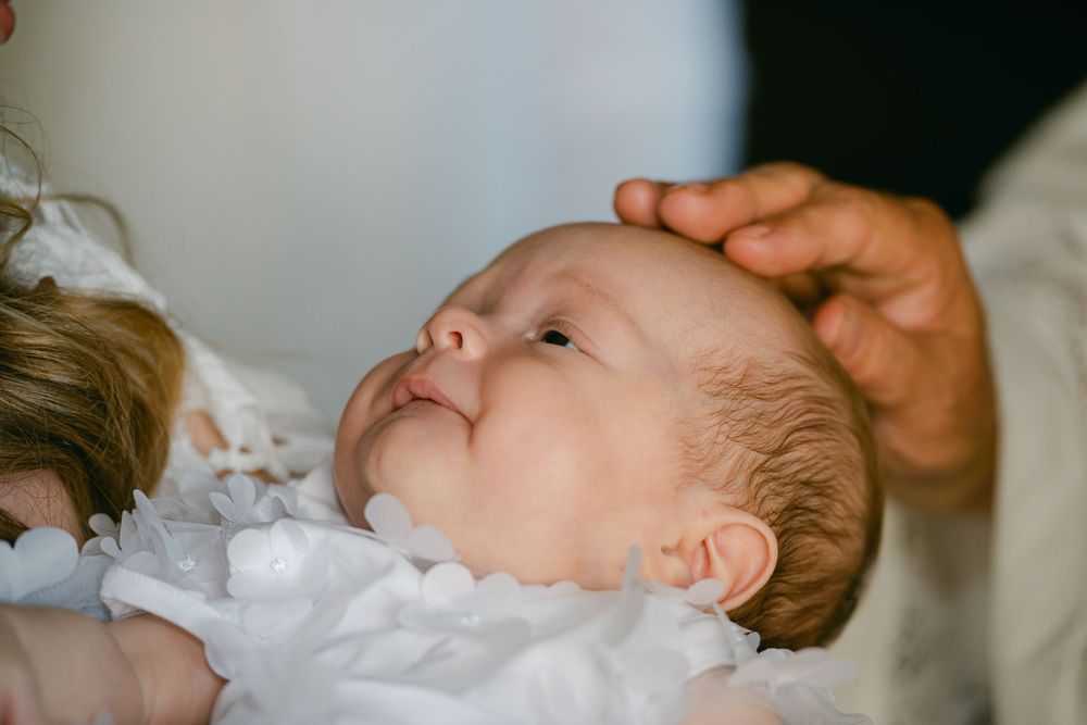 Series of closeup shots showing a baby being fed milk from a bottle.