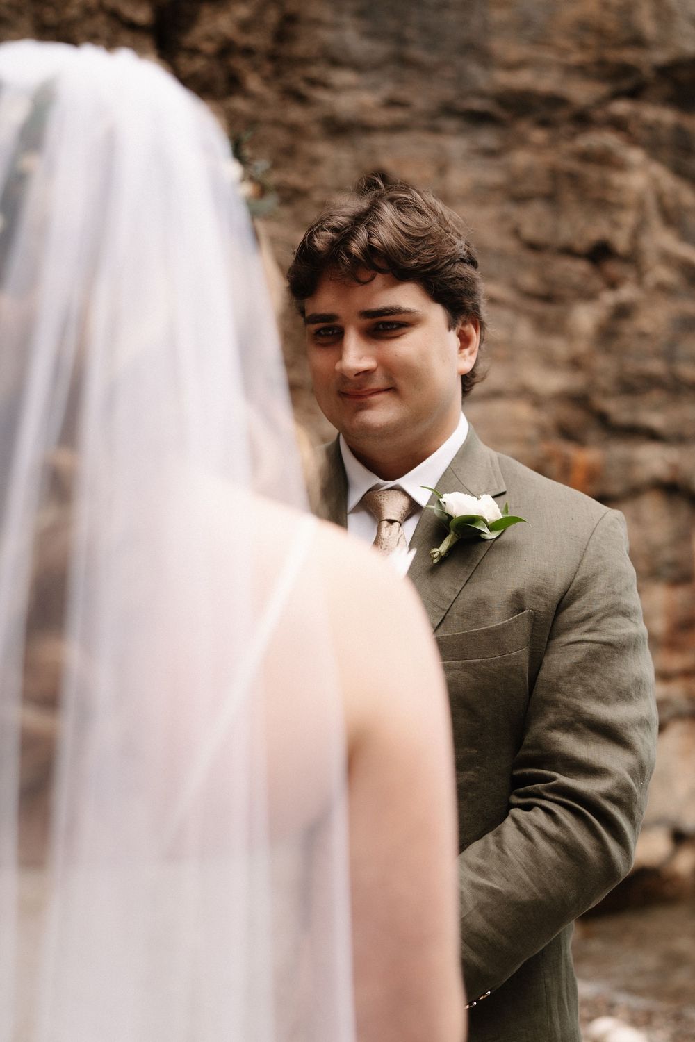Series of five cropped wedding photos in light beige tones showing emotional reactions during first look ceremony.
