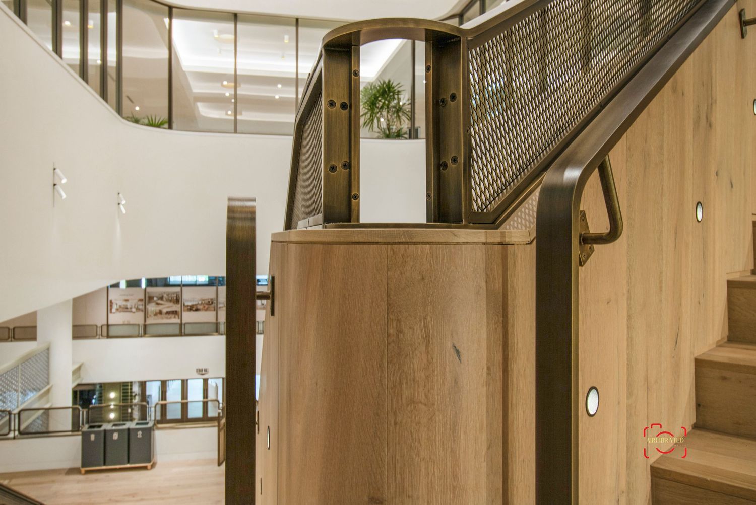 Wooden staircase and interior hallway with modern architectural details in neutral tones.