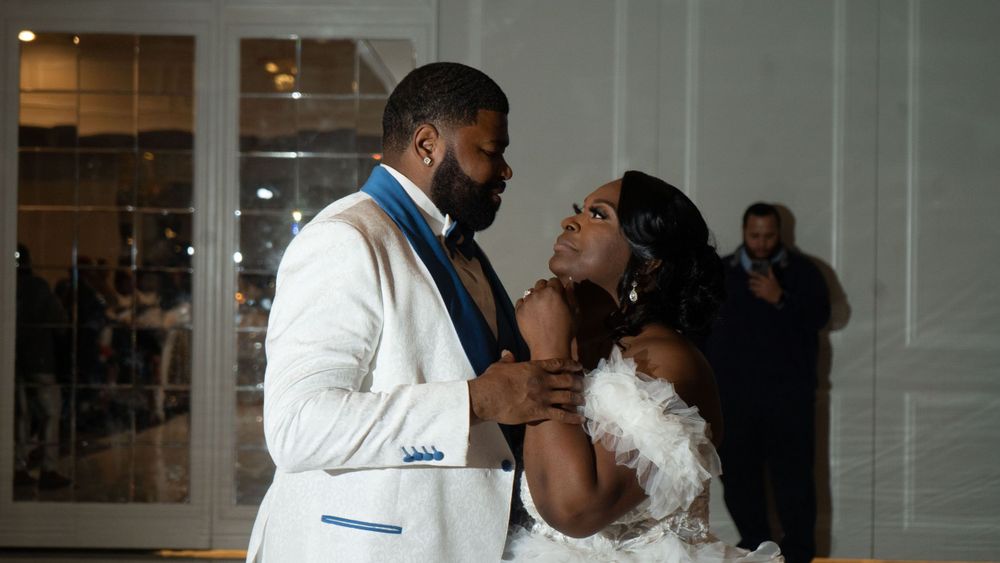 Newlyweds sharing an intimate moment during their wedding reception celebration.