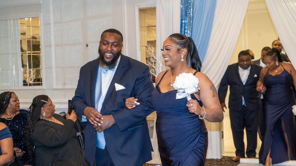Wedding party members dancing and celebrating during reception.