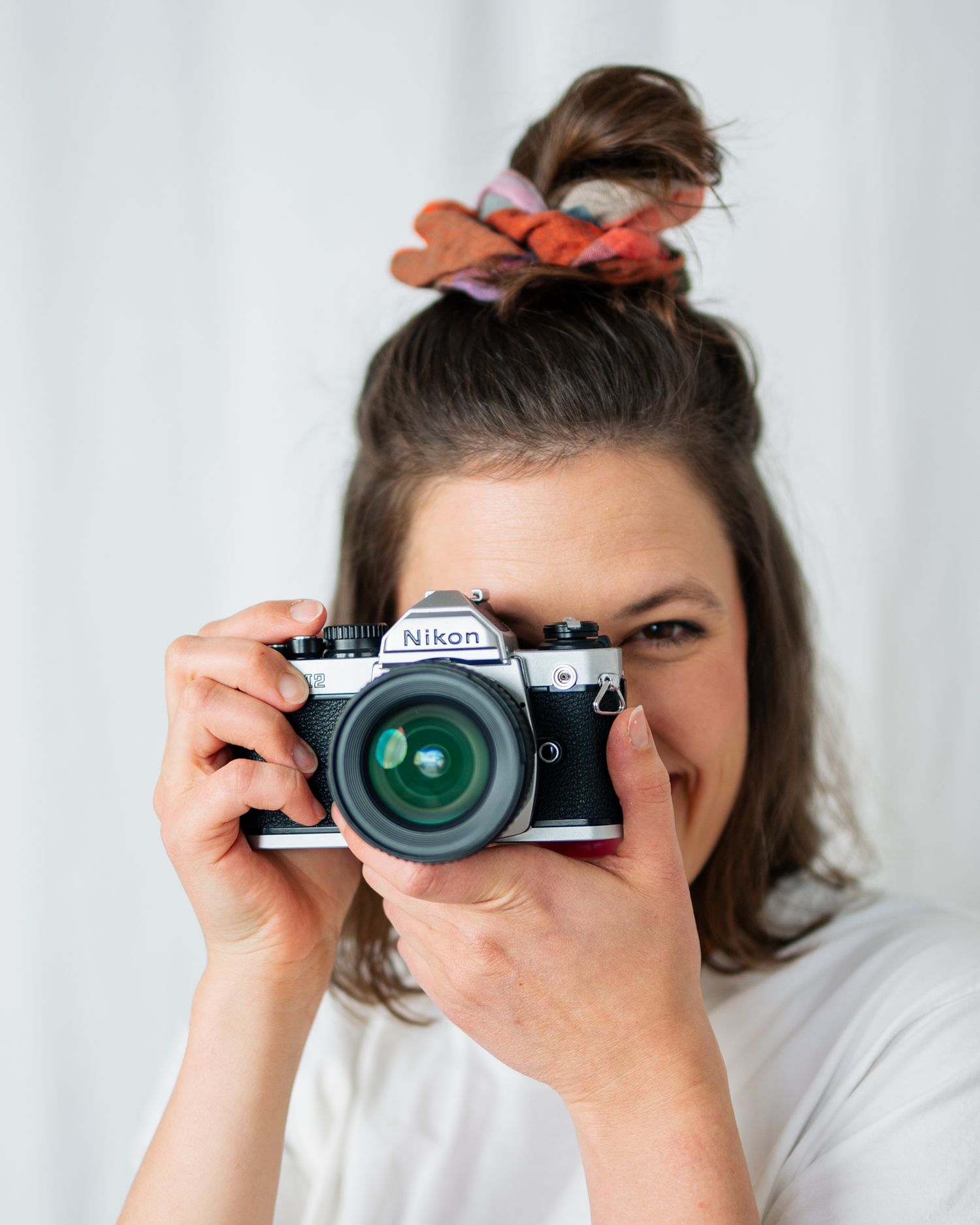Sequence showing someone using a vintage film camera against white background.