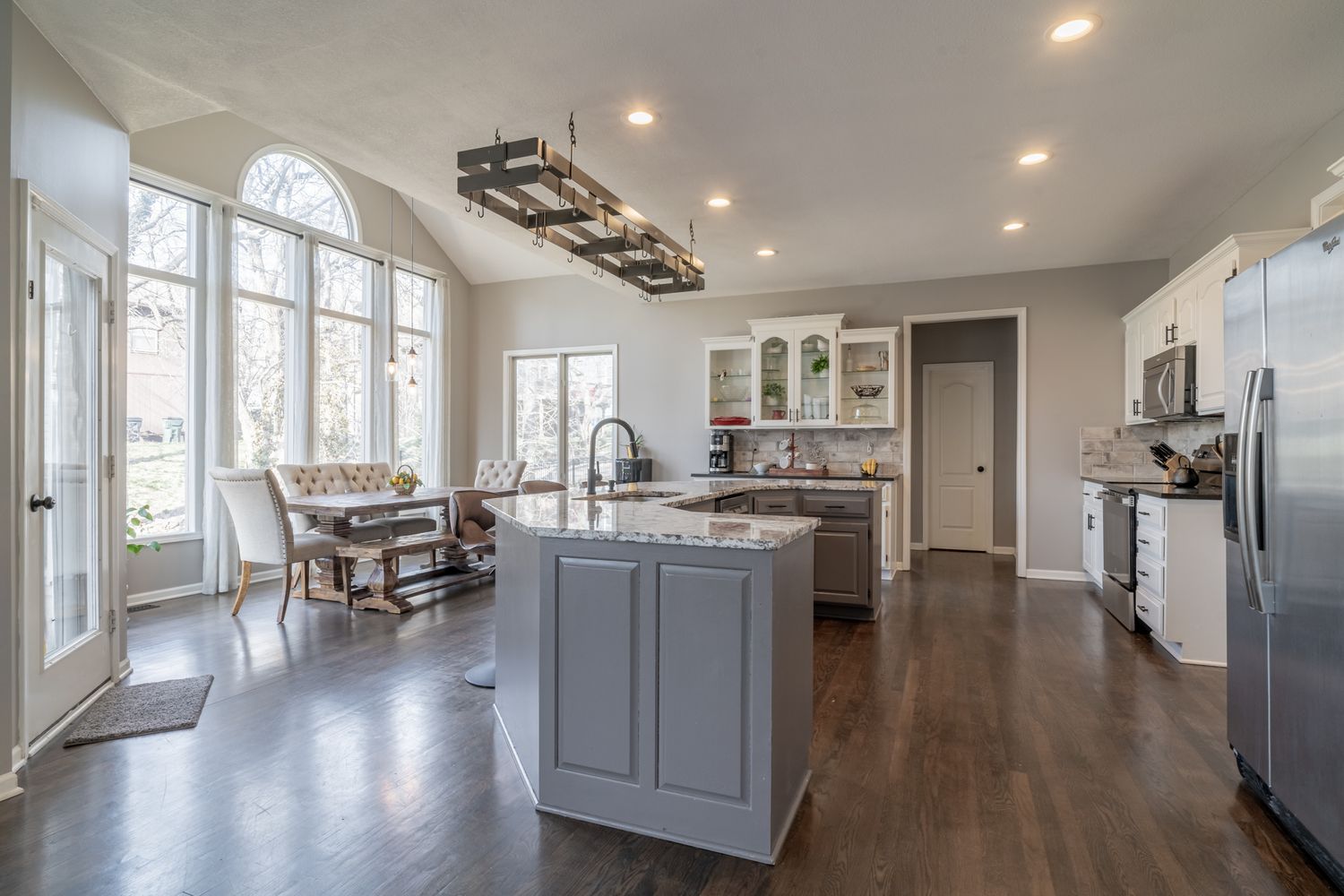 Bright kitchen with a center island, pendant lighting, and tall windows, photographed by Cody Callaway Photography.