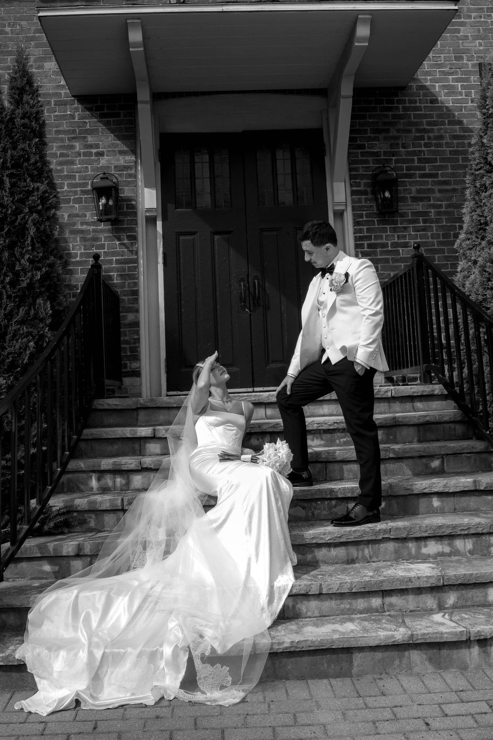 A sequence of black and white wedding photos showing a couple dancing gracefully on brick steps outside a building.