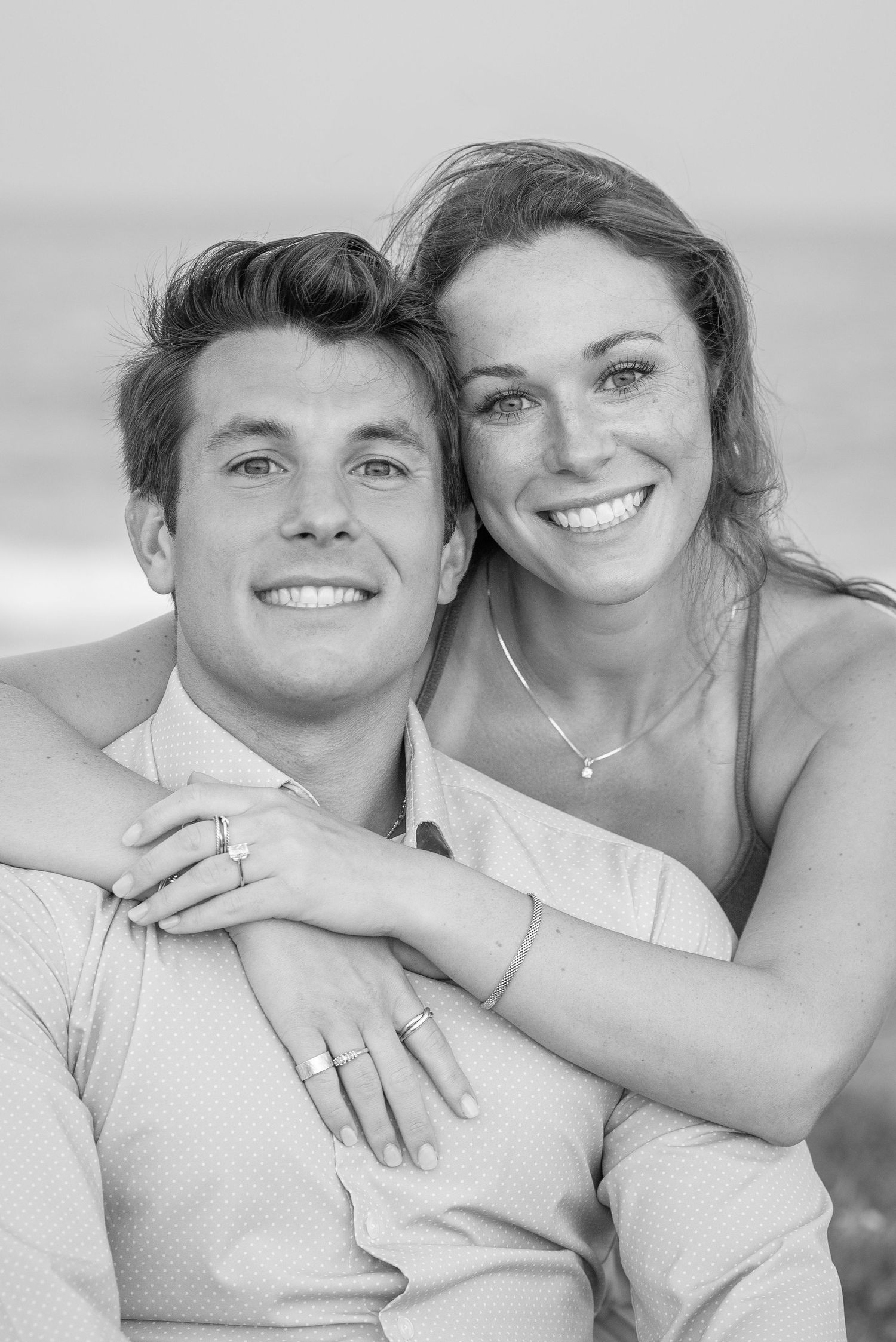 Black and white engagement photos showing a couple's joyful expressions.