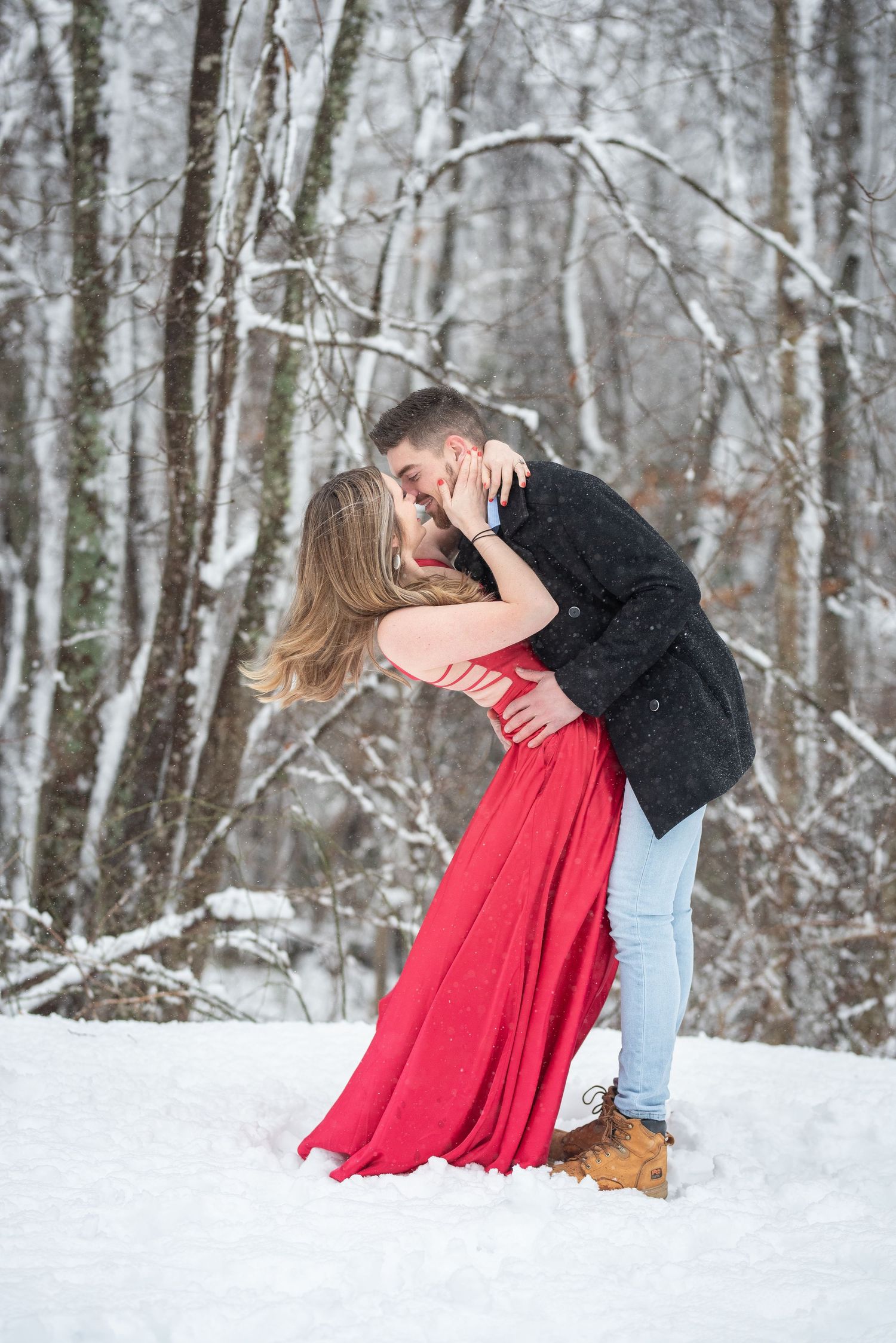 Romantic dance sequence in snowy winter forest with red dress.