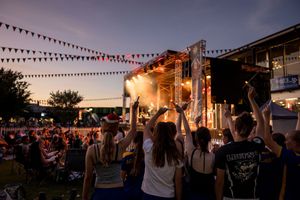 A crowd waving candles watching the 2025 Albury Christmas Carols at QE 2 Square, photos by Jason Robins