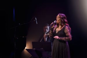 Albury Wodonga event photography by Jason Robins capturing a live stage vocal and musical performance under corporate theatre lighting.