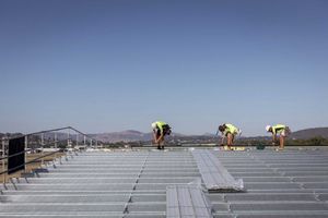 Albury Wodonga commercial construction photography by Jason Robins capturing roofers installing steel deck roofing on an industrial build.