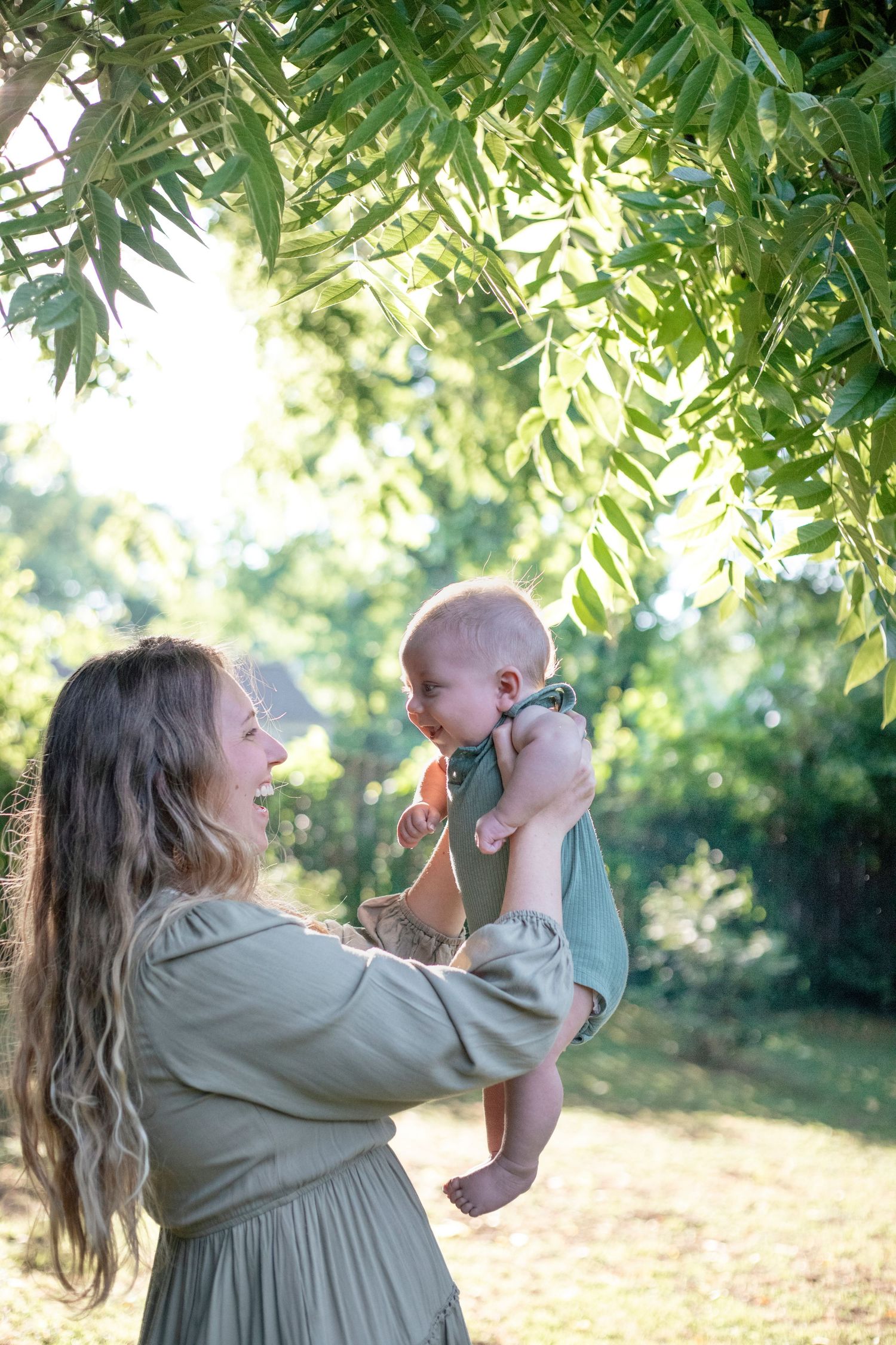 new mom kissing head of newborn baby